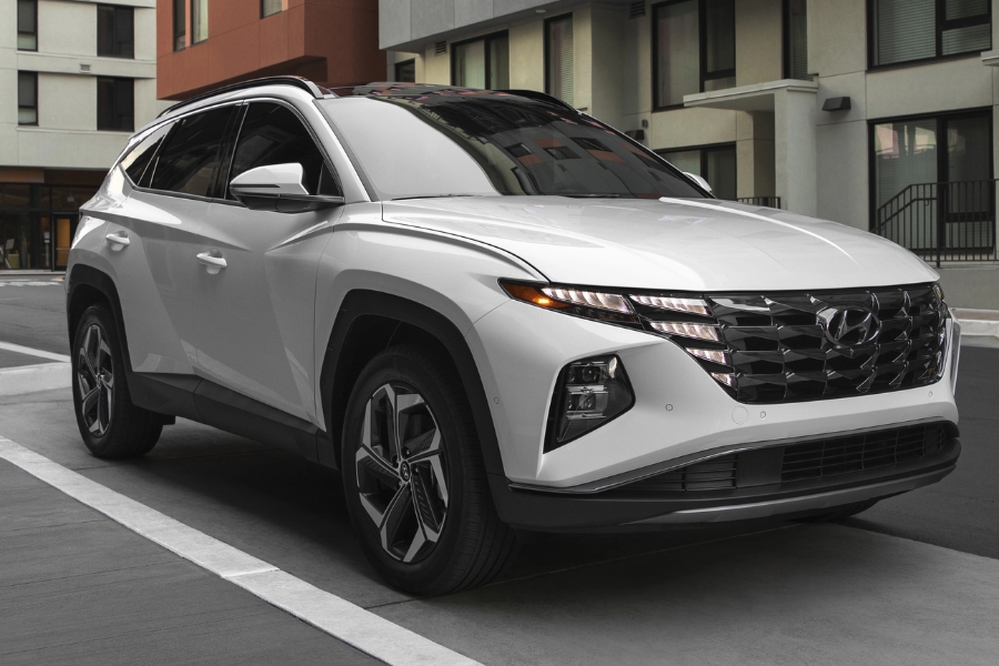 white Hyundai Tucson Hybrid on city road